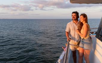 A couple looks at the sunset on the Crazy Sister Marina sunset cruise.