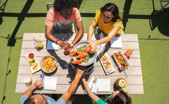 Friends enjoying a meal at Riptydz, an oceanfront restaurant.