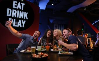 Friends taking selfie at Dave & Buster's