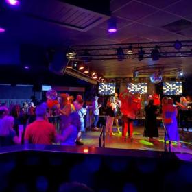 People dancing on a dance floor in a night club