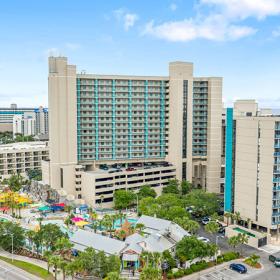 Aerial of Sand Dunes Resort with pool and waterpark with beach in background