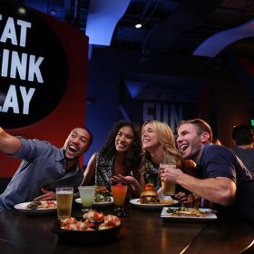 Dave and Busters friends at table taking selfie