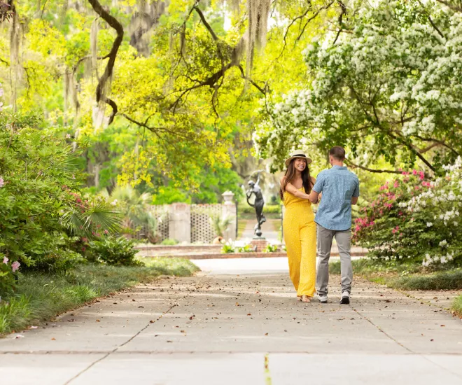 Couple walking through Brookgreen Gardens