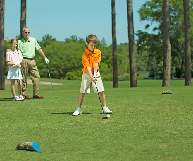 Family of four golfing