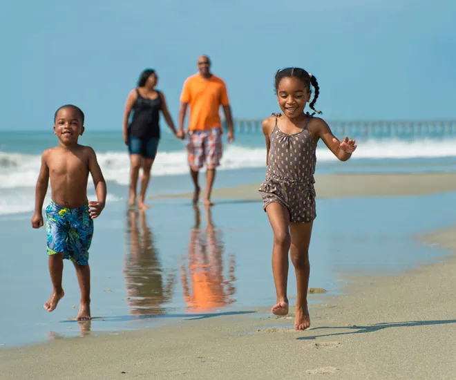 Children running on the beach