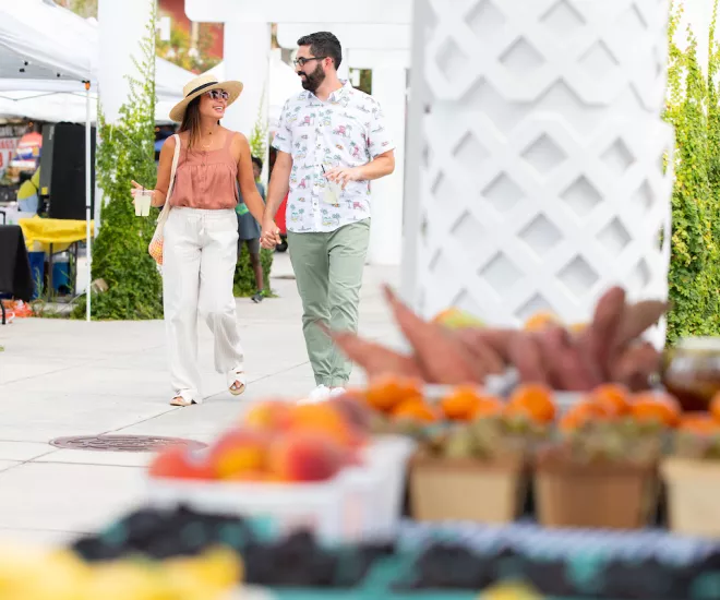 Couple walking through farmers market