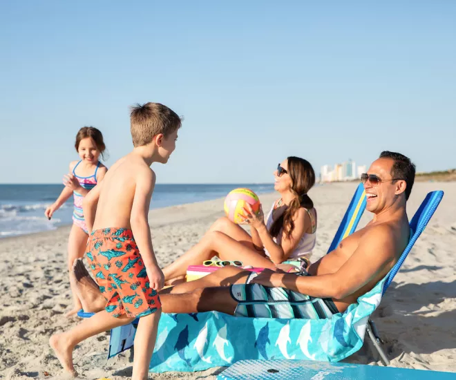 Family playing on the beach