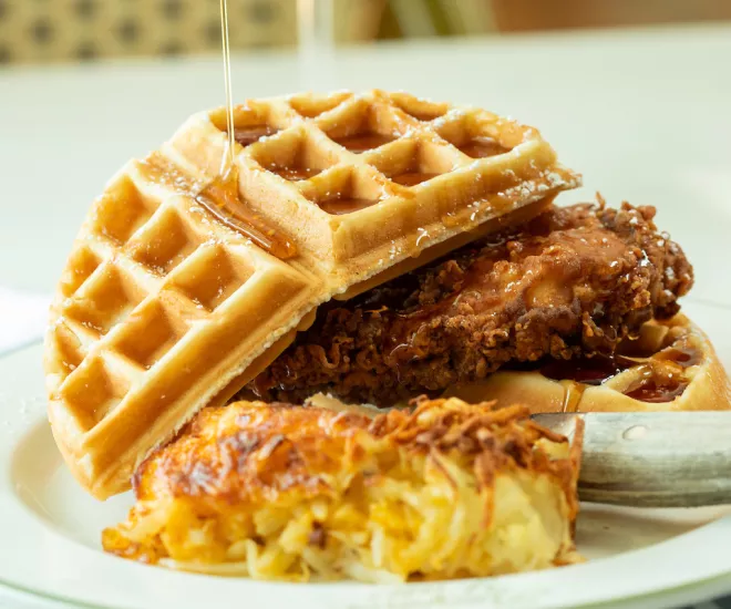 Chicken and Waffles from Croissants with syrup drizzled on top