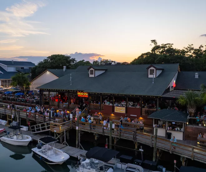 MarshWalk drone shot with the sunset over the restaurants