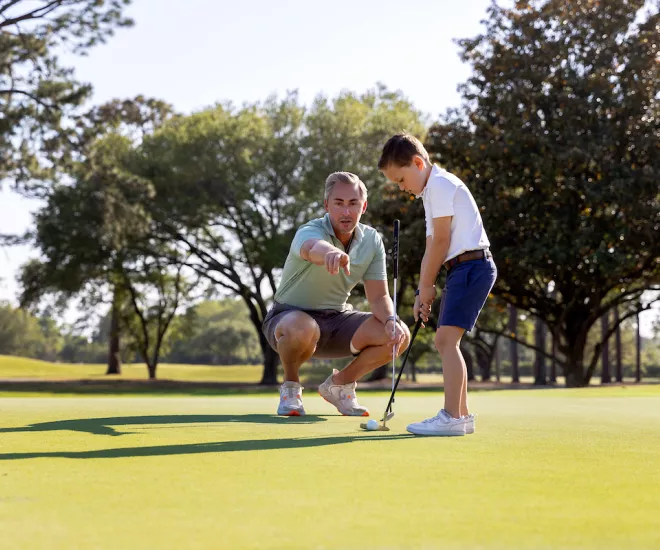 Dad and Son playing golf together