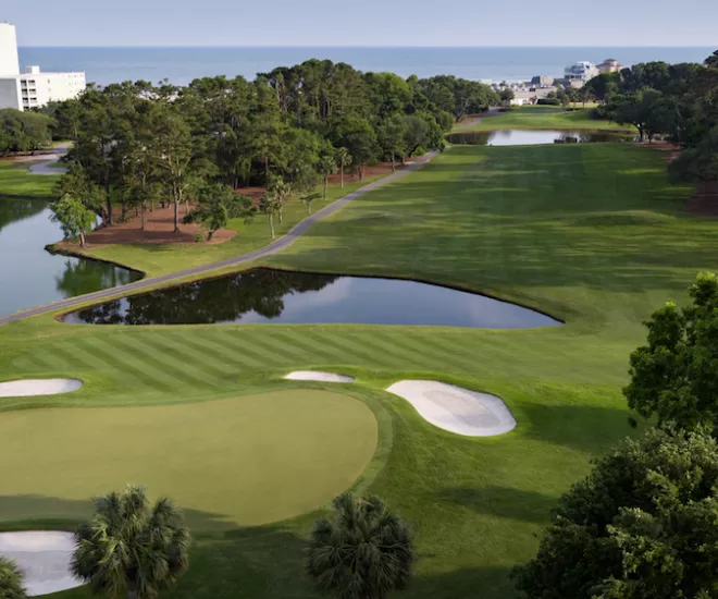 Dunes Golf aerial with ponds, greens, traps and ocean