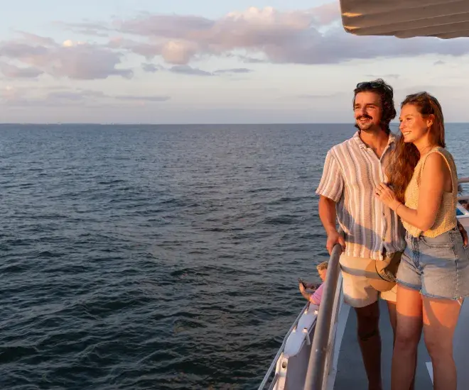 A couple looks at the sunset on the Crazy Sister Marina sunset cruise.