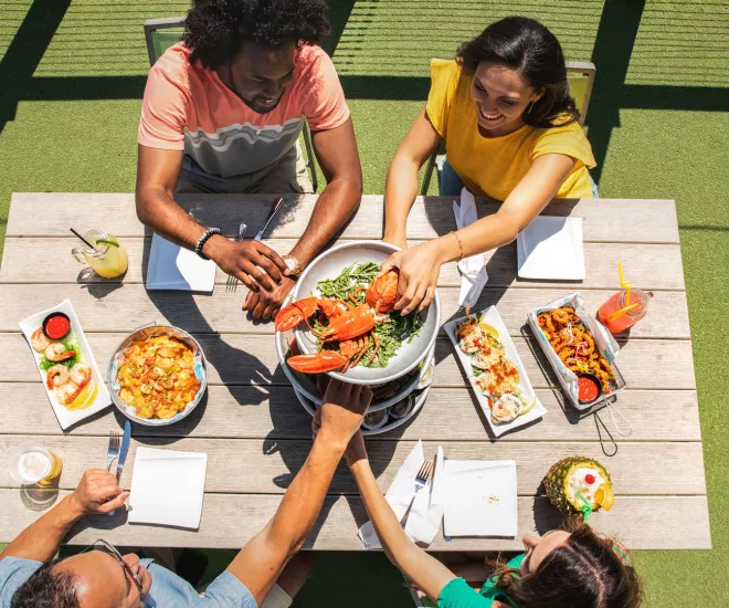 Friends enjoying a meal at Riptydz, an oceanfront restaurant.