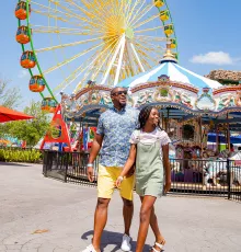 Couple Walking by Carousel