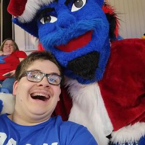 Happy fan with the Blue Demon mascot