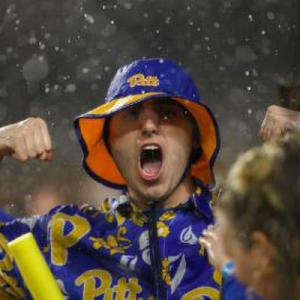 Pitt fan in rain with Pitt bucket hat and raincoat