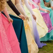 Princesses wearing gowns in various colors shown from waist down