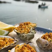 Neptune Bistro oysters with a view of inlet with boat