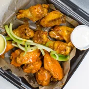 Wings CO wings with sauces in a to go box