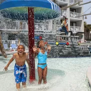 Captain's Quarters kids under waterfall at waterpark