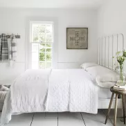 bedroom with crisp white linens and towels