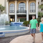 South Wind couple walking by front fountain