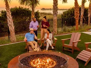 Meeting Professionals sitting around firepit