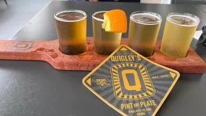 Quigley's beer flight with branded coaster