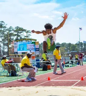 Long Jumping in a Track Meet at The Beach
