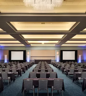 Convention Center ballroom classroom style set up with two large screens