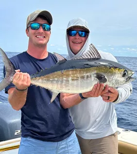 North Island Fishing Charters two buddies on a boat holding big fish