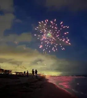 Fireworks at dusk over Surfside Beach on the beach