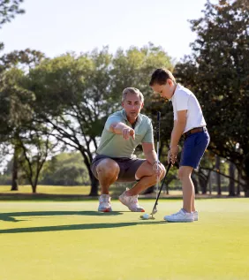 Dad and Son playing golf together