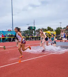 Track &amp; Field women's participants running on track