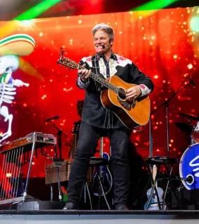 Greg Rowles Legacy Theater Greg on stage with guitar