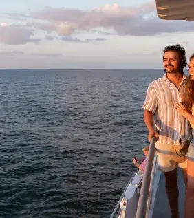 A couple looks at the sunset on the Crazy Sister Marina sunset cruise.