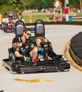 Vistors racing go-karts at the Broadway Grand Prix.