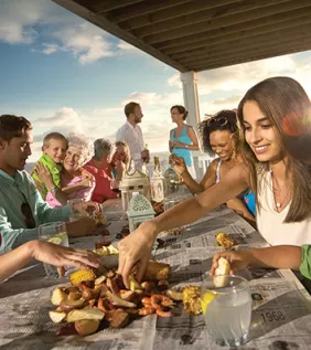 Vistors enjoying an outdoor, southern seafood boil.