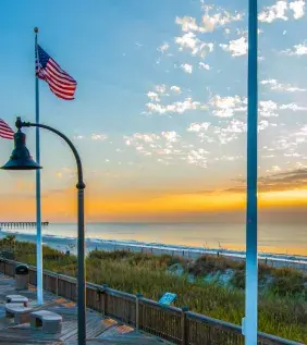 The Myrtle Beach boardwalk waking up to a yellow sunrise.