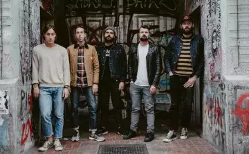 The group standing in graffiti doorway
