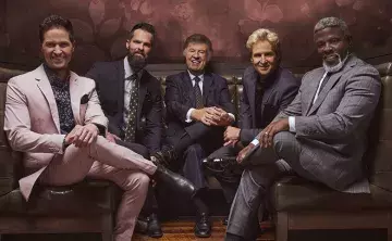 The five members of the Gaither Vocal Band sitting