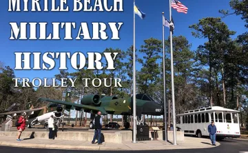 Image of Valor Park with Military planes and tour participants