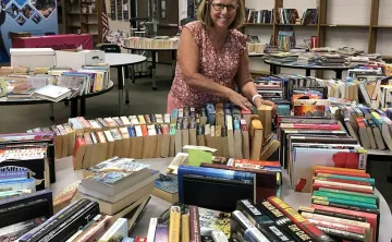 Lots of books in racks and bookshelves