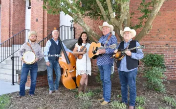 Members of the The End of the Road Bluegrass Band with instruments