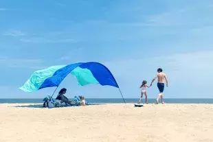 Family on beach with Shibumi Shade
