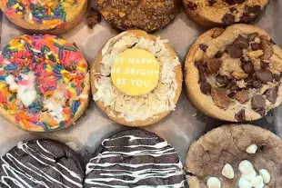 A variety of cookies and cakes with sprinkles, chocolate chips and drizzles