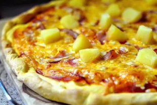 Close up of cheese pizza with pineapple topping