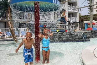 Captain's Quarters kids under waterfall at waterpark