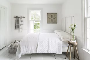 bedroom with crisp white linens and towels