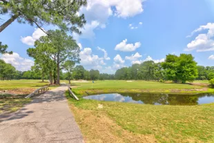 Azalea Sand course with tree and lake among golf cart path